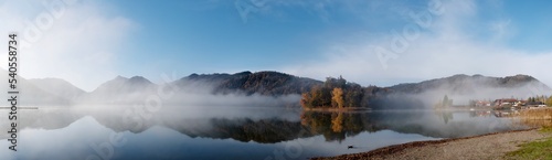 Autumn morning fog on the lake. Panorama.