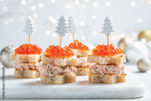 Christmas tree canape with Smoked Salmon, Cream Cheese, Dill, Horseradish Pate and red caviar for festive xmas snack photo