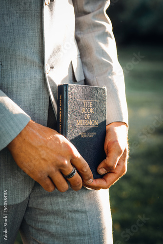 hands of a person with book of mormon photo