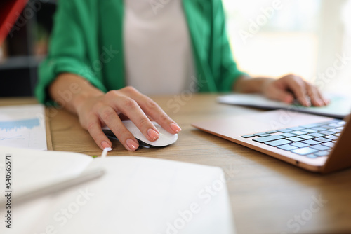 Female working on modern laptop in office