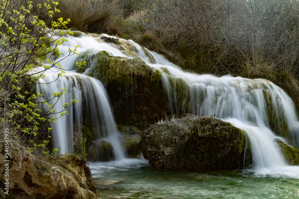 waterfall with silky effect in waters of turquoise and green tones in lagoons with trees and bushes in autumn tones waterfall with silky effect in waters of turquoise and green tones in lagoons with trees and bushes in autumn tones