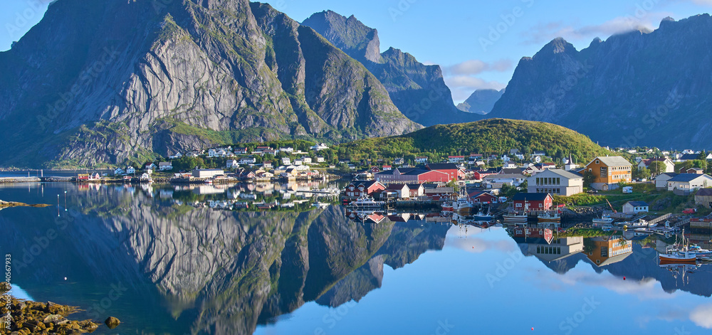 Panoramic view on fishing village Reine, one of the most beautiful villages in Norway. Steep mountains at the background. The most beautiful hiking area in Lofoten. Summer vacation, tourist attraction