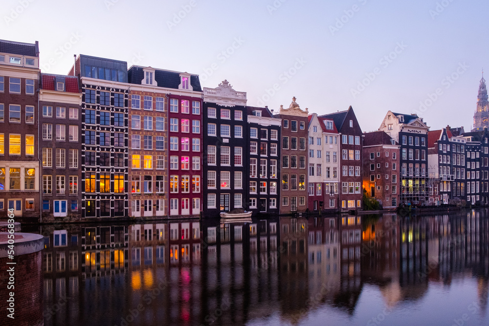 Amsterdam: a view of the canal with a row of colorful houses in the background