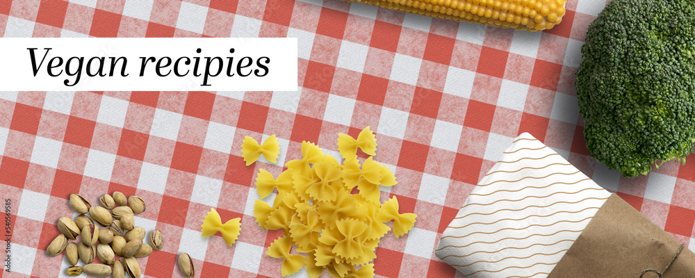 Fototapeta premium variety of cooking ingredients and message VEGAN RECIPIES on kitchen table background