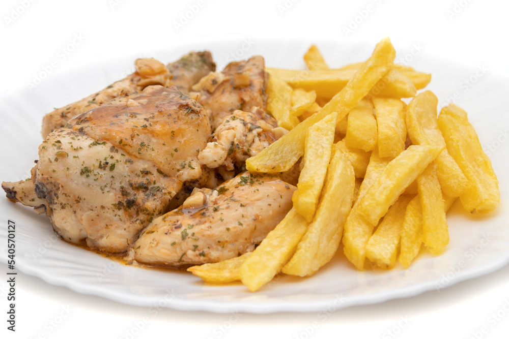 A plate of garlic chicken with pommes frites. On white background. Spanish food concept. A plate of garlic chicken with pommes frites. On white background. Spanish food concept.