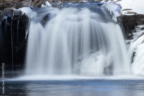 waterfall cascades over the ice in the mountains of Pennsylvania