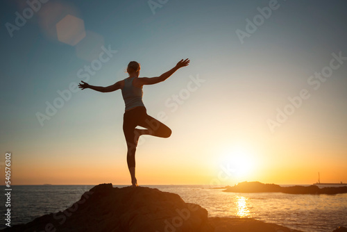 Yoga woman meditation on the Sea beach seeing off the sun.