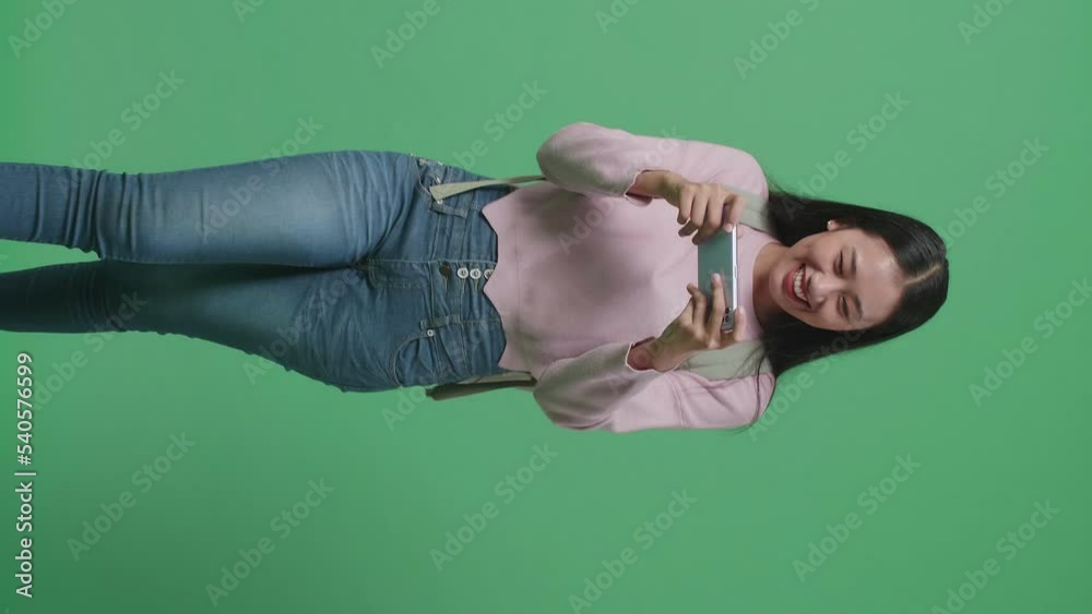 Excited Asian Woman Student Playing Mobile Game While Walking On Green Screen Studio
Excited Asian Woman Student Playing Mobile Game While Walking On Green Screen Studio