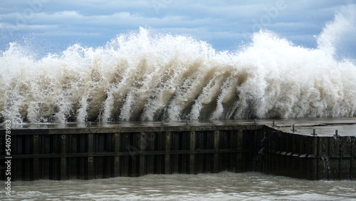 A wave crashes into a break wall along Lake Michigan’s shoreline at Tower Beach in Winnetka, Illinois, on a very windy day. photo