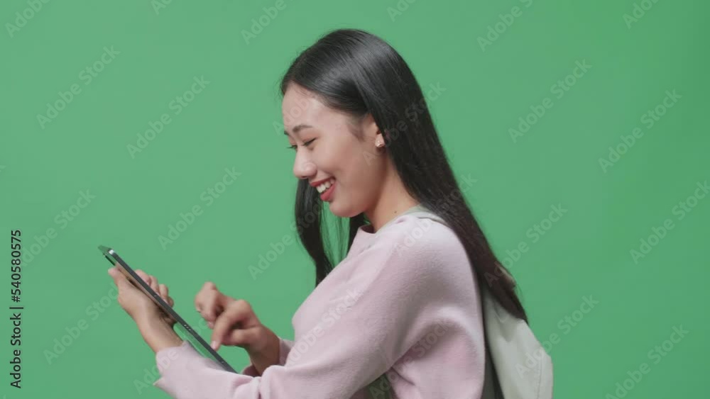 Side View Of Asian Woman Student Using Tablet And Walking On Green Screen Studio
Side View Of Asian Woman Student Using Tablet And Walking On Green Screen Studio