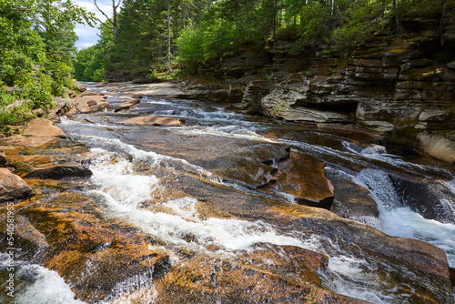 Water flowing across the rocks of Lower Falls of the Ammonoosuc River in rural NH photo