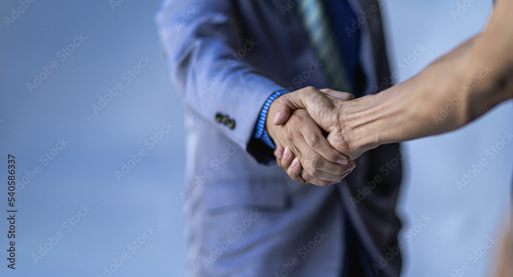 Young businessmen shaking hands in the office Completing a successful meeting
of teamwork, cooperation and handshake greetings