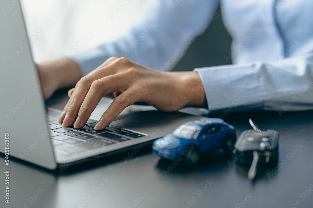 Car rental sales concept, Asian businesswoman working with toy cars on the table. Concepts of cars, property, ownership, insurance and transportation. Car rental sales concept, Asian businesswoman working with toy cars on the table. Concepts of cars, property, ownership, insurance and transportation.