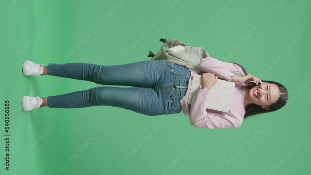 Full Body Of Asian Woman Student Talking On Mobile Phone In Green Screen Studio
Full Body Of Asian Woman Student Talking On Mobile Phone In Green Screen Studio