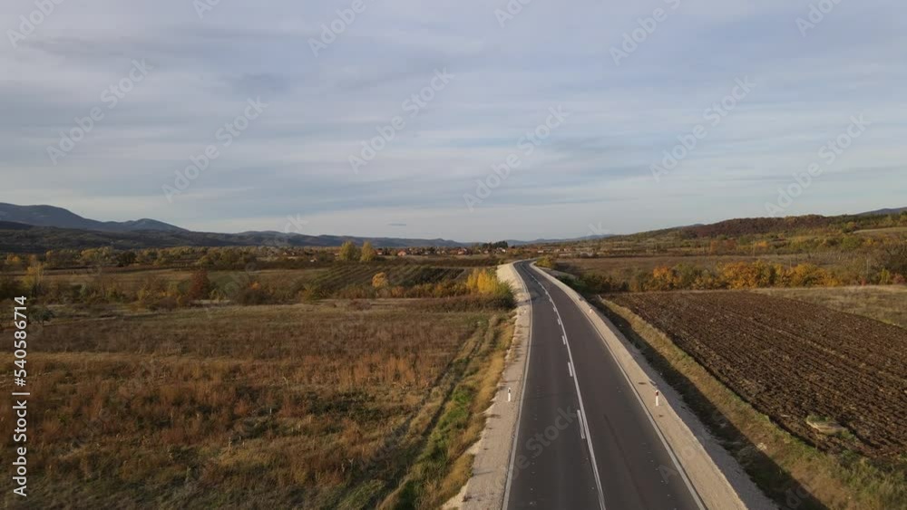 Drone video on the road in east serbia trough the fields in nature rural scene in autumn day Drone video on the road in east serbia trough the fields in nature rural scene in autumn day