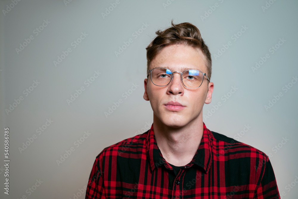 Studio shot closeup of young serious man with eyeglasses Studio shot closeup of young serious man with eyeglasses