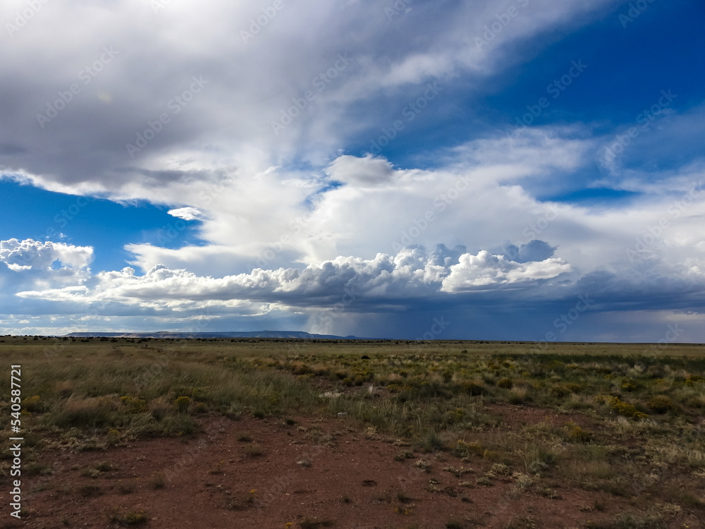 Thunderstorm Clouds Raining Across the Prairie on the Horizon