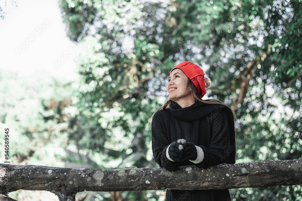 Portrait of Happy Asian young woman in winter costume at the forest with copy space Portrait of Happy Asian young woman in winter costume at the forest with copy space