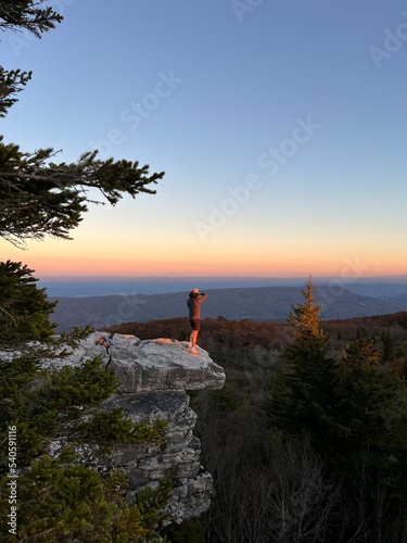 Man Takes Photographs on Cliff at Sunset, West Virginia