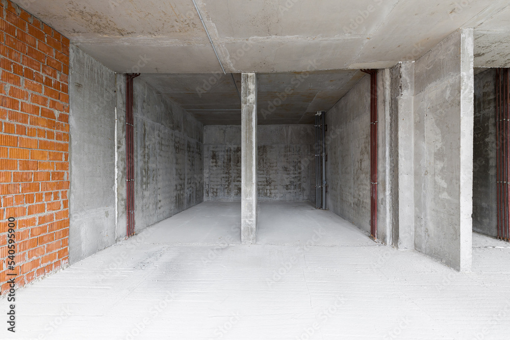 Empty concrete commercial space without finishing with partitions Empty concrete commercial space without finishing with partitions