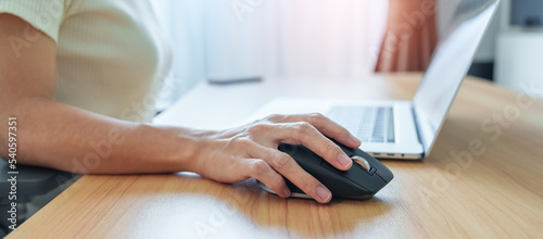 Fotografie, Obraz woman hand using ergonomic vertical mouse during working on Adjustable desk, prevention wrist pain
