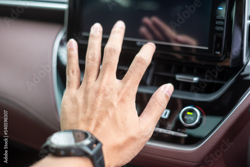 man hand checking the air flowing during driving car on the road, air conditioner cooling system inside the car. Adjust, temperature and transport concept