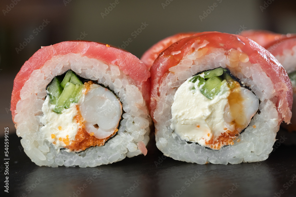 Sushi set, Japanese food, sushi roll with tuna and tiger shrimp on black stone background Sushi set, Japanese food, sushi roll with tuna and tiger shrimp on black stone background