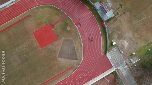 Aerial Top Panning Shot Of Sports People Practicing Running In Stadium - Bakersfield, California photo