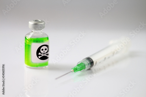 Medical vial of a neon green substance and hypodremic needle. Concept of addiction. 