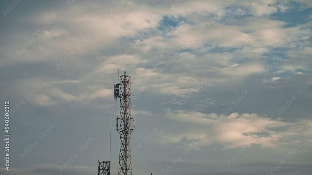 Transmitter cellular tower to strengthen and expand the network with cloudy sky background Transmitter cellular tower to strengthen and expand the network with cloudy sky background