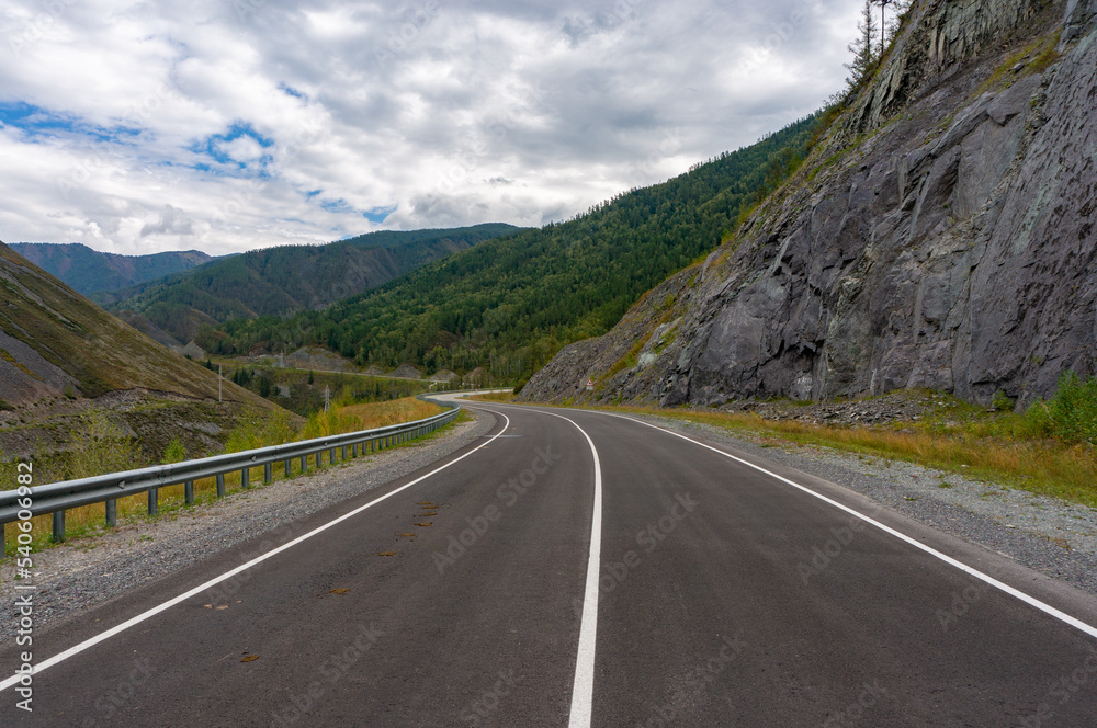A road surrounded by mountains in the Altai Republic. Gorny Altai A road surrounded by mountains in the Altai Republic. Gorny Altai