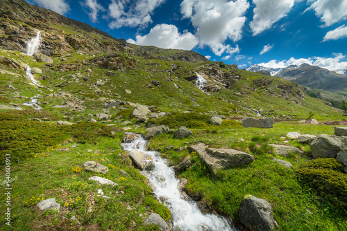 Ethereal waterfall and alpine meadows at springtime, Gran Paradiso Alps, Italy