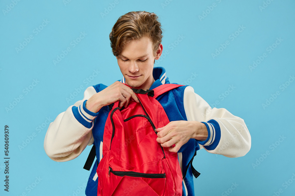 guy student with a red backpack dressed backwards