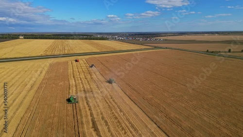 Different Agriculture Machines Harvesting Grain in Wheat Field Drone Point of View.