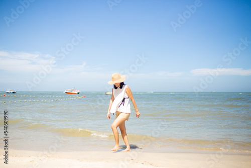beautiful happy woman walking down the beach