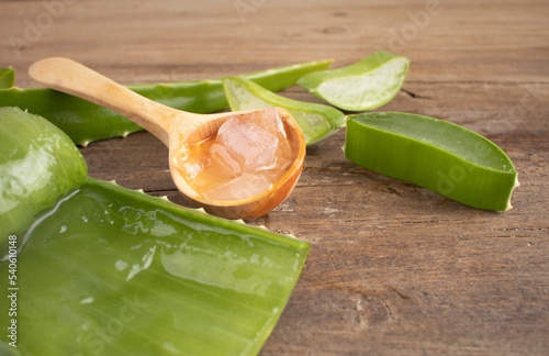Aloe vera in a spoon on wood.