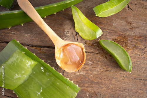 Aloe vera in a spoon on wood.