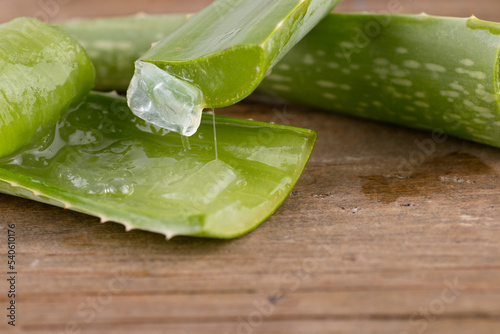 Aloe vera in a spoon on wood.