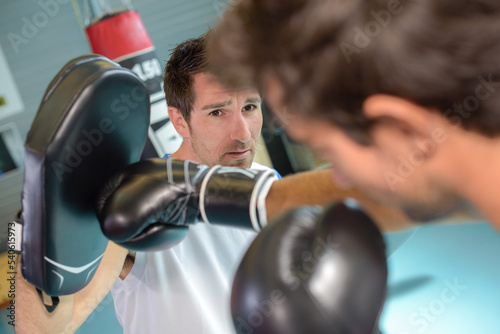 a man boxing with his trainer
