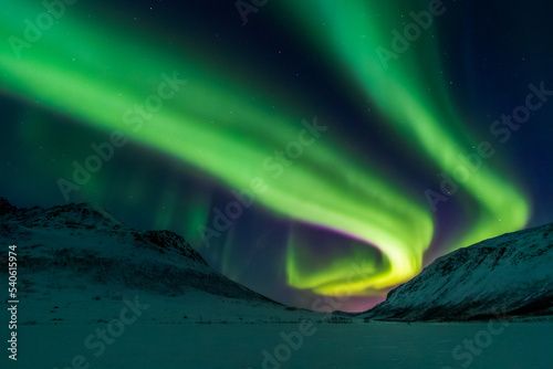 Northern lights over snowy valley