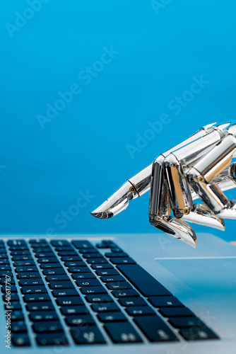 Obraz na płótnie Robot hand pointing to laptop