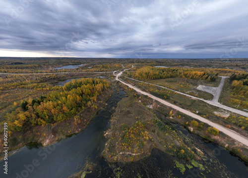panoramic view from a drone of a network of lakes and islands with a yellow forest against the backdrop of autumn colors © константин константи