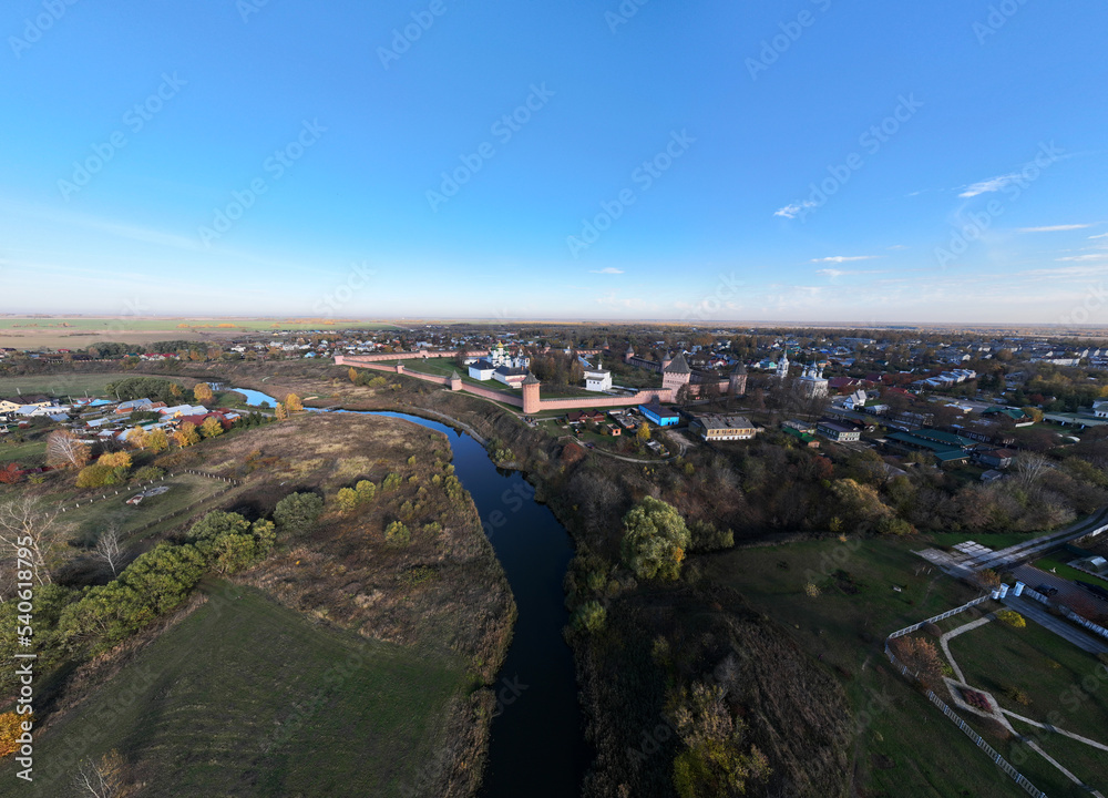 panoramic view from a drone of an ancient monastery with sentries against the backdrop of autumn colors in Suzdal