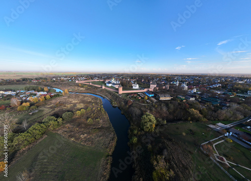 panoramic view from a drone of an ancient monastery with sentries against the backdrop of autumn colors in Suzdal