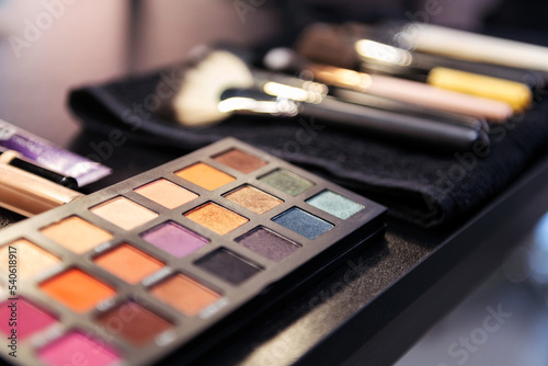 color palette and brushes in the workplace of a professional makeup artist, concept of beauty salon and skin care photo