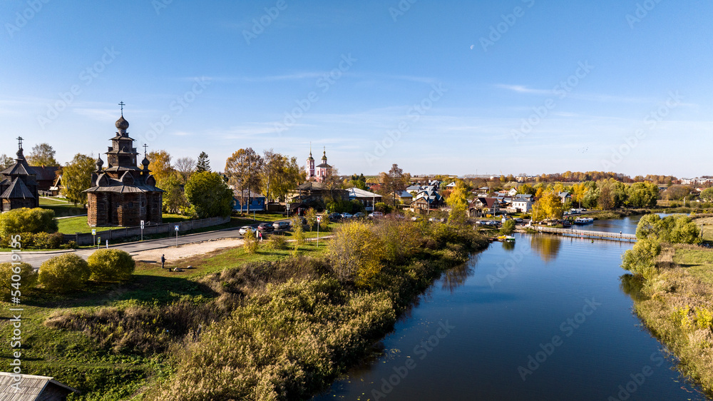 panoramic view from a drone of ancient buildings and fields and forests against the backdrop of autumn colors in Suzdal