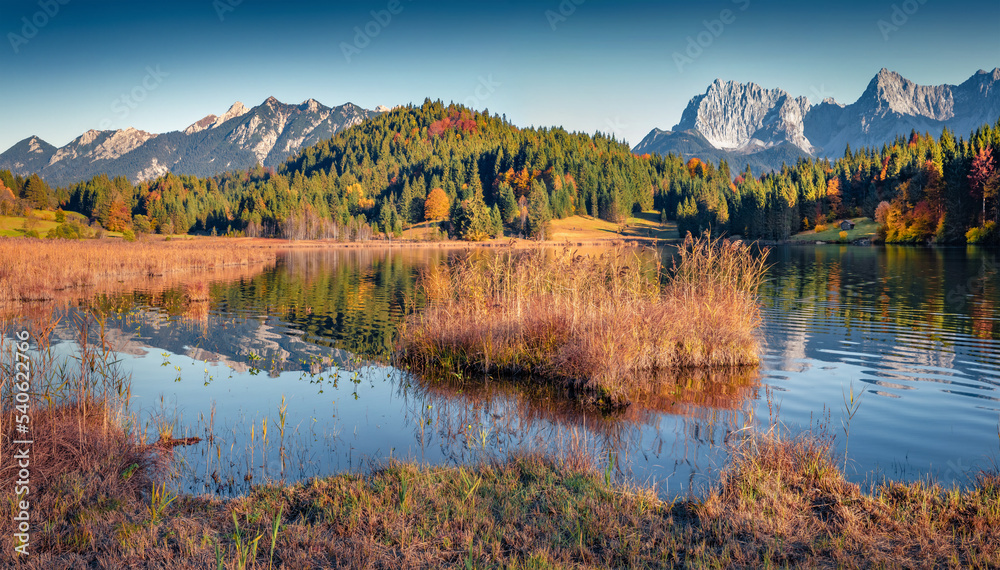 Beautiful autumn scenery. Attractive morning view of Wagenbruchsee (Geroldsee) lake with Westliche Karwendelspitze mountain range on background. Splendid landscape of Bavarian Alps, Germany.