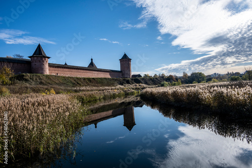 ancient stone monastery against the backdrop of autumn nature in Suzdal