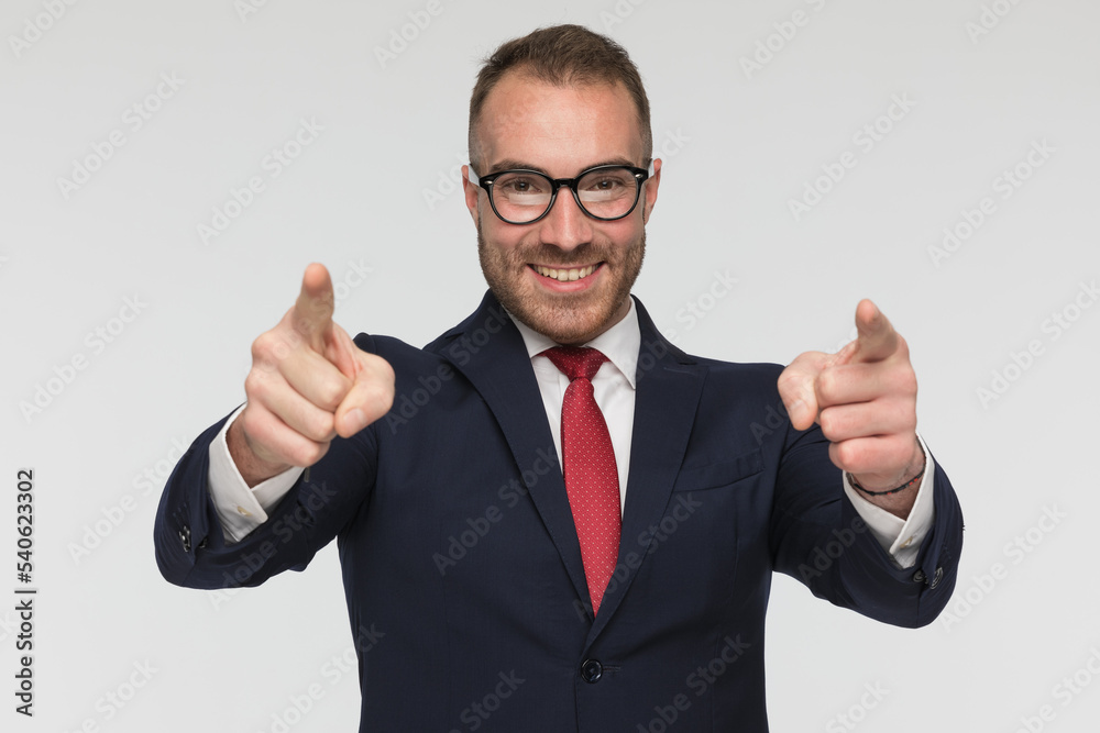happy businessman is pointing at the camera happy businessman is pointing at the camera