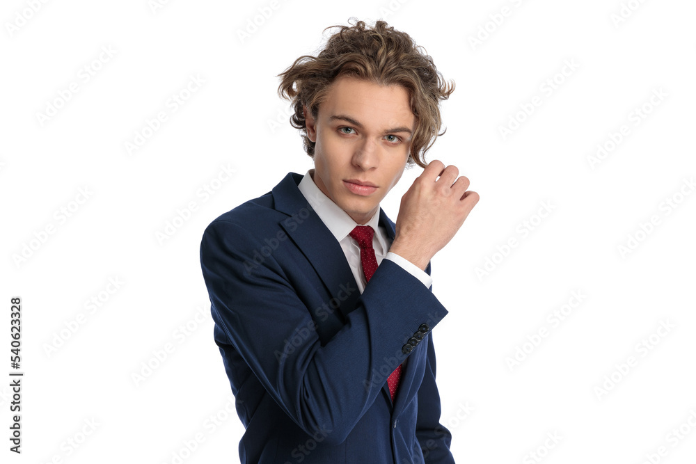 handsome man in elegant suit adjusting blond hair handsome man in elegant suit adjusting blond hair